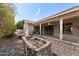 View of back of house with covered patio and rock planter at 1505 Leisure World --, Mesa, AZ 85206