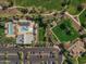 Aerial view showcasing a community pool, ramadas, parking area, and green park space at 15432 W Corrine Dr, Surprise, AZ 85379