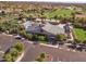 Aerial view of community center with pool, parking, and a lush green field in a suburban neighborhood at 15432 W Corrine Dr, Surprise, AZ 85379