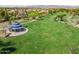 Aerial view of park featuring a charming gazebo, green lawns, mature trees and walking paths at 15432 W Corrine Dr, Surprise, AZ 85379