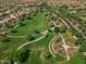 Aerial view featuring a large green park with walking paths and mature trees in a residential area at 15432 W Corrine Dr, Surprise, AZ 85379