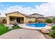 Beautiful backyard features a pool, fountain, and turf at 15432 W Corrine Dr, Surprise, AZ 85379