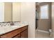 Bathroom featuring granite countertop, tiled backsplash, and a shower with glass door at 15432 W Corrine Dr, Surprise, AZ 85379