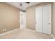 This bedroom has sliding-door closet, neutral walls, carpet flooring and leads to the hallway at 15432 W Corrine Dr, Surprise, AZ 85379