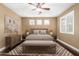 Cozy bedroom with decorative rug, bench, window shutters, and calming neutral color scheme at 15432 W Corrine Dr, Surprise, AZ 85379