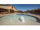 A view of a community pool featuring water fountains and seating areas with overhead shade at 15432 W Corrine Dr, Surprise, AZ 85379