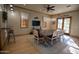 Cozy dining room area with a large wooden table, seating for eight, and natural light at 15432 W Corrine Dr, Surprise, AZ 85379