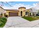 Charming home featuring a two-car garage, well-manicured lawn, and unique architectural details like a turret entrance at 15432 W Corrine Dr, Surprise, AZ 85379