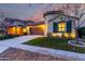 Charming home featuring a two-car garage, well-manicured lawn, and unique architectural details like a turret entrance at 15432 W Corrine Dr, Surprise, AZ 85379