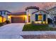 Charming home featuring a two-car garage, well-manicured lawn, and unique architectural details like a turret entrance at 15432 W Corrine Dr, Surprise, AZ 85379