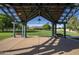 Enclosed gazebo provides a serene view of the property's verdant lawn and charming two-story house in the distance at 15432 W Corrine Dr, Surprise, AZ 85379