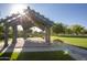 Charming gazebo with a pergola and shaded seating surrounded by a meticulously maintained lawn, adding elegance at 15432 W Corrine Dr, Surprise, AZ 85379