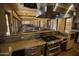 View of the kitchen area with stainless steel appliances, granite countertops, and a pass-through bar at 15432 W Corrine Dr, Surprise, AZ 85379