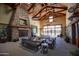 Inviting community lounge area with a stone fireplace, seating, and a decorative chandelier at 15432 W Corrine Dr, Surprise, AZ 85379