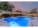 Beautiful pool with surrounding desert landscaping creating a private outdoor oasis in the backyard at 15432 W Corrine Dr, Surprise, AZ 85379