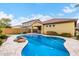 Outdoor living area featuring a private backyard pool surrounded by mature landscaping, offering a refreshing retreat at 15432 W Corrine Dr, Surprise, AZ 85379