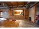 Room featuring a service window to kitchen area, wood look flooring, and overhead industrial lighting at 15432 W Corrine Dr, Surprise, AZ 85379