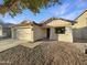 House exterior showcasing a two-car garage and stone driveway at 1642 W La Salle St, Phoenix, AZ 85041