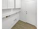 Laundry room with white cabinets and tile flooring at 1642 W La Salle St, Phoenix, AZ 85041