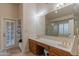 Bathroom features double vanity, a large mirror, and shower with glass enclosure at 17045 N 58Th Way, Scottsdale, AZ 85254