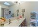 Bathroom with single sink vanity, and linen shelving at 17045 N 58Th Way, Scottsdale, AZ 85254