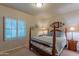 Spacious bedroom with wood framed bed, and window shutters at 17045 N 58Th Way, Scottsdale, AZ 85254