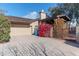 Two-car garage with driveway and vibrant red flowers at 17045 N 58Th Way, Scottsdale, AZ 85254