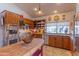 Kitchen with double oven, granite countertops, and warm wood cabinetry at 17045 N 58Th Way, Scottsdale, AZ 85254