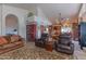 Open living area with leather sofas and a view into kitchen at 17045 N 58Th Way, Scottsdale, AZ 85254