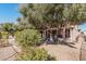 Landscaped backyard with mature trees and gravel at 18132 N Villa Bella Dr, Surprise, AZ 85374