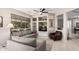 Living room with grey sofas, built-in shelving and a large window at 18132 N Villa Bella Dr, Surprise, AZ 85374