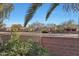 View of backyard with block wall and neighborhood at 18205 N Divet Ln, Surprise, AZ 85374