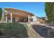 Landscaped backyard with rock pathway and pergola at 18205 N Divet Ln, Surprise, AZ 85374