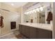 Bathroom boasts double sinks, a large mirror and a shower at 18205 N Divet Ln, Surprise, AZ 85374