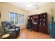 Home office with built-in wooden shelving, a comfortable chair and a desk at 18205 N Divet Ln, Surprise, AZ 85374