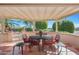 Covered patio with seating area and outdoor dining at 18205 N Divet Ln, Surprise, AZ 85374