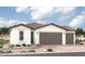 Single-story home with two-car garage and desert landscaping at 18240 W Hess St, Goodyear, AZ 85338