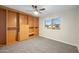 Bedroom with built-in shelving, ceiling fan and window view at 1825 W Seldon Way, Phoenix, AZ 85021