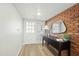 Modern entryway featuring a brick accent wall and console table at 1825 W Seldon Way, Phoenix, AZ 85021