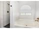 Spa-like bathroom featuring a soaking tub and a walk-in shower at 18825 N 34Th St, Phoenix, AZ 85050