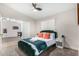 Charming bedroom with a green velvet bed frame and adjoining game room at 18825 N 34Th St, Phoenix, AZ 85050