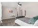 Bedroom with gray upholstered bed, white desk and ceiling fan at 18825 N 34Th St, Phoenix, AZ 85050