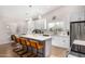 Modern kitchen with white cabinets, marble countertops, and breakfast bar at 18825 N 34Th St, Phoenix, AZ 85050