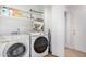 Convenient laundry room with washer, dryer, and shelving at 18825 N 34Th St, Phoenix, AZ 85050