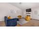 Living room features blue sofa, yellow armchairs, and a fireplace at 18825 N 34Th St, Phoenix, AZ 85050