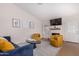 Living room features blue sofa, yellow armchairs, and a fireplace at 18825 N 34Th St, Phoenix, AZ 85050