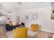 Living room with blue sofa, yellow chairs, and view into kitchen at 18825 N 34Th St, Phoenix, AZ 85050