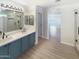 Elegant bathroom with dual sinks, a large mirror, and a walk-in shower at 2014 N 94Th Gln, Phoenix, AZ 85037