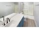 Updated bathroom with a white vanity and a bathtub at 2014 N 94Th Gln, Phoenix, AZ 85037