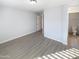 Bedroom with wood-look floors and access to bathroom at 2014 N 94Th Gln, Phoenix, AZ 85037